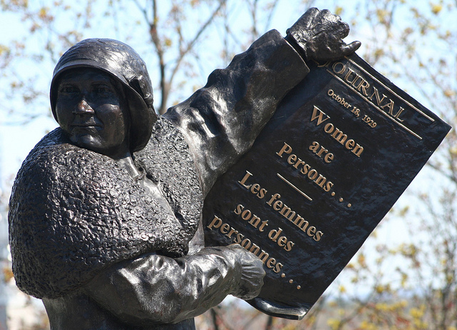 Statue of Nellie McClung holding Women Are Persons paper